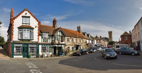 Historic buildings around the square in Yarmouth, with the church tower behind